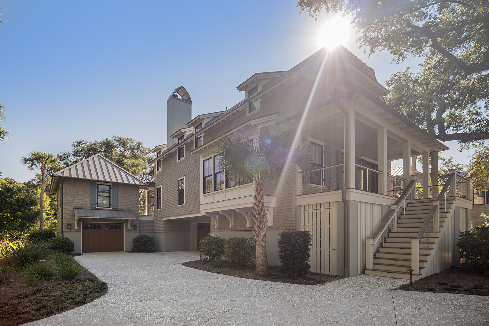 Shingled Kiawah Island, SC home with a crushed-shell drive, live oaks and palmettos
